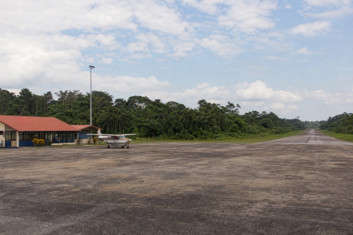 A small plane sits on the runway at Iquitos airport, the gateway for Iquitos Amazon tours into the jungle