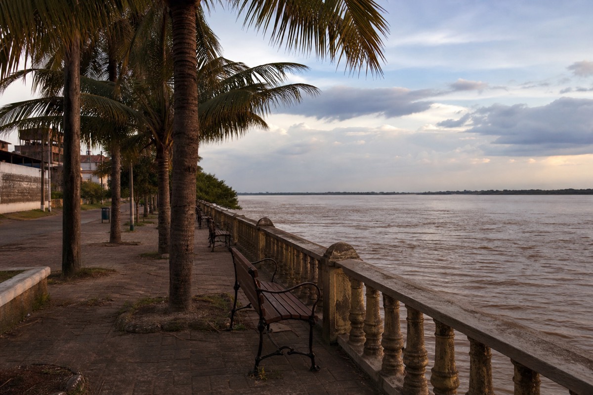 Benches along the riverfront promenade, a common stop on Iquitos Amazon tours, with the river beside